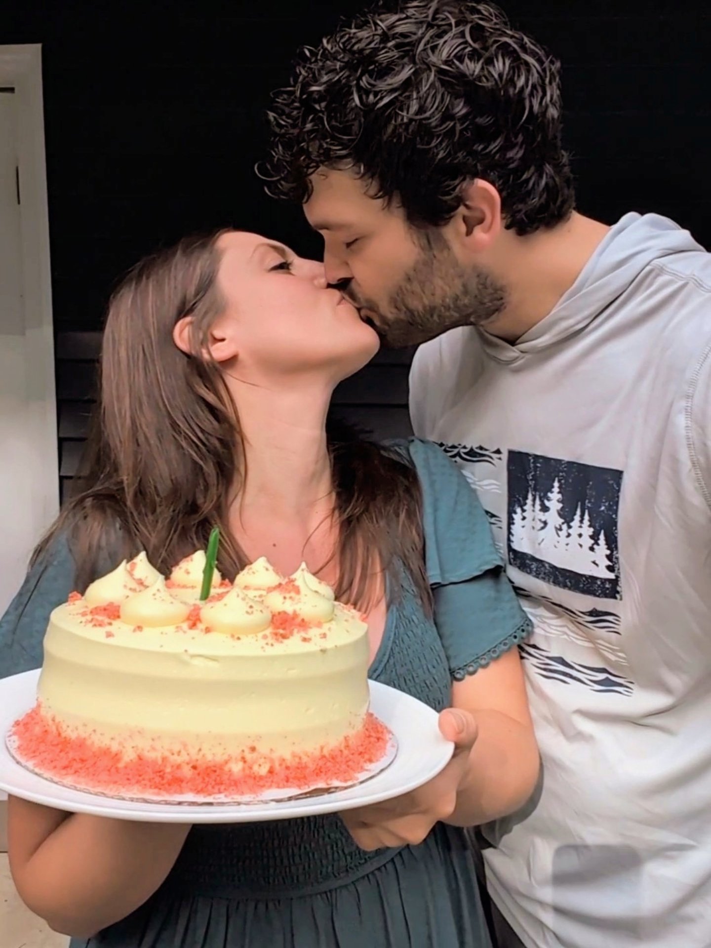 Couple kissing with cake